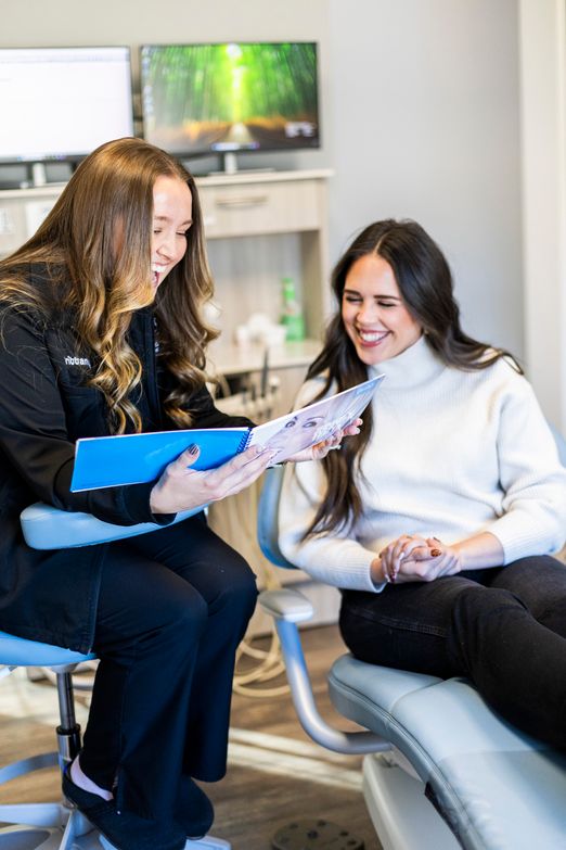 A Lake Bowen Dental Studio team member reviewing treatment options with a patient during a consultation
