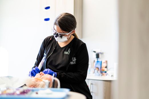 A Lake Bowen Dental Studio dental hygienist cleaning a patient’s teeth during a routine dental visit