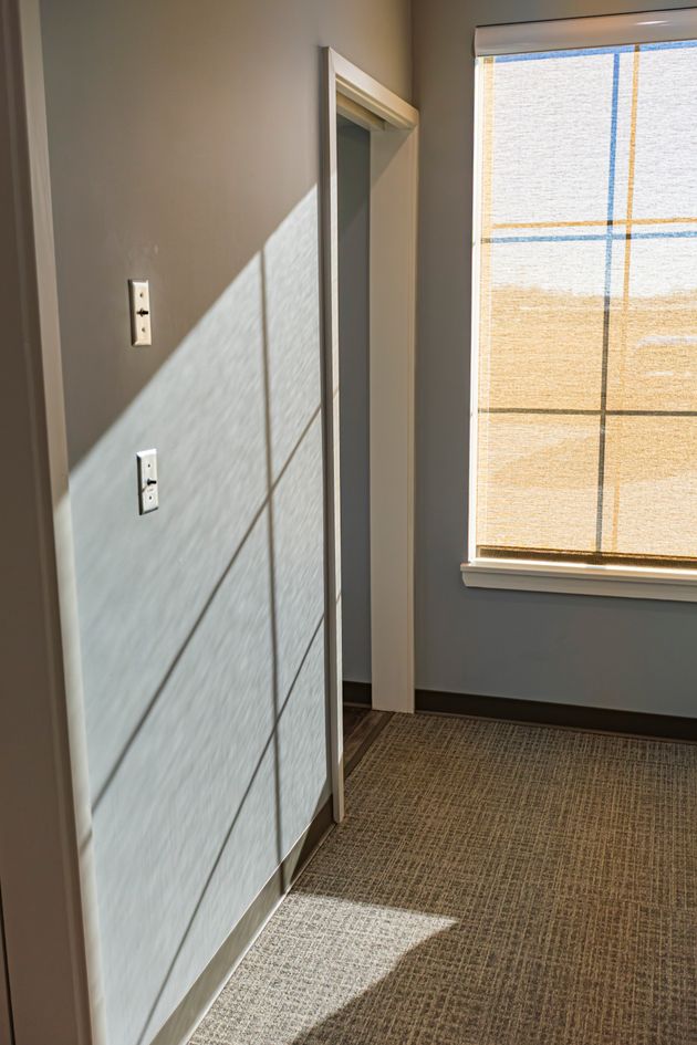 Interior view of dental office hallway with natural light coming through window and clean modern design