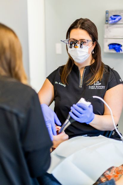 Dr. Kacey using a digital scanner on a patient