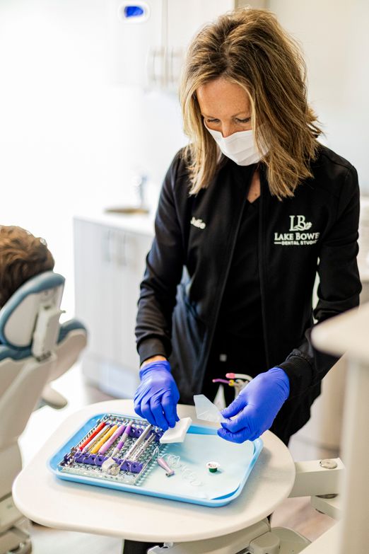 A Lake Bowen Dental Studio dental hygienist preparing a tray with dental tools for a filling procedure