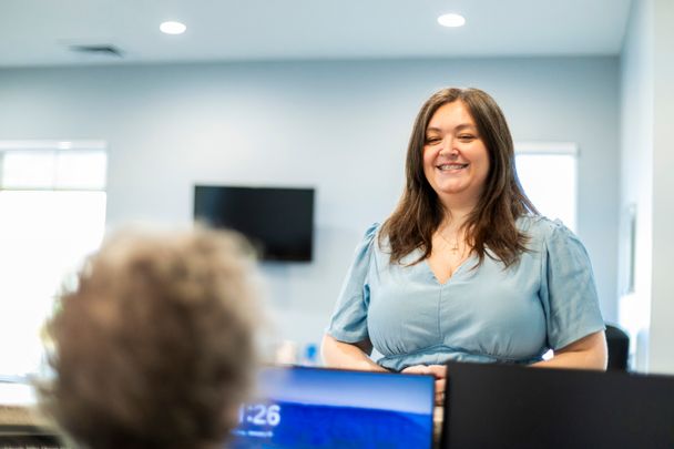 Friendly patient checking in at the front desk