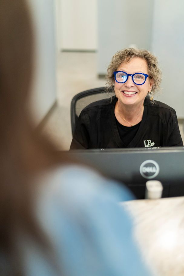 Friendly front desk receptionist greeting a patient