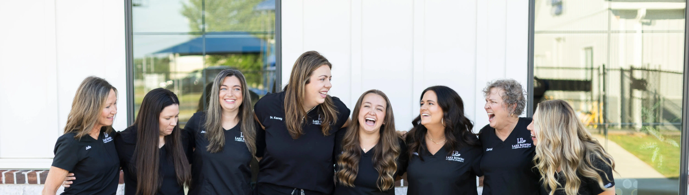 The Lake Bowen Dental Studio team laughing together outside the office