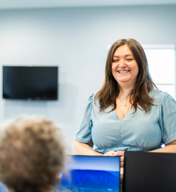 Friendly front desk receptionist greeting a patient at Lake Bowen Dental Studio
