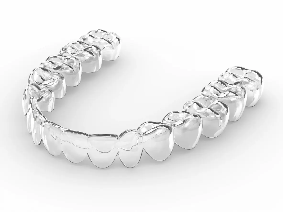 clear dental aligners on model teeth
